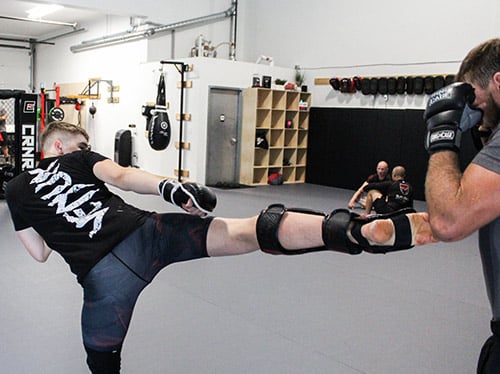 Marco of Black Rock Martial Arts teaches young students how to perform accurate taekwondo kicks.