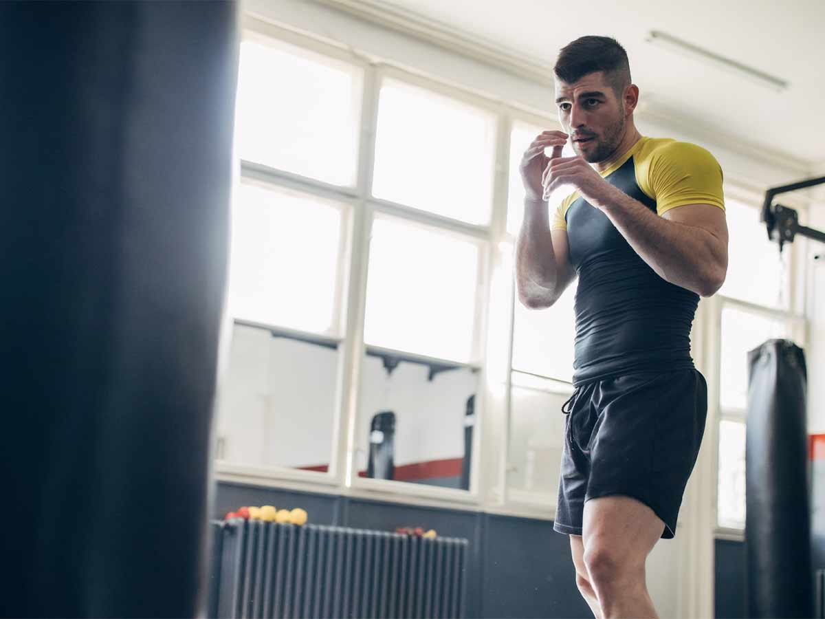 A muscular man with dark hair is in a defnsive stance as he prepares to practice at a martial arts gym in Qualicum Beach.